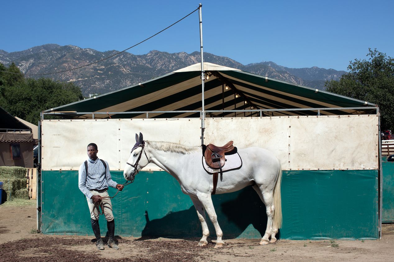 Portrait of a male equestrians with his horse next to a tent, Ilona Szwarc, editorial photographer, Los Angeles.  