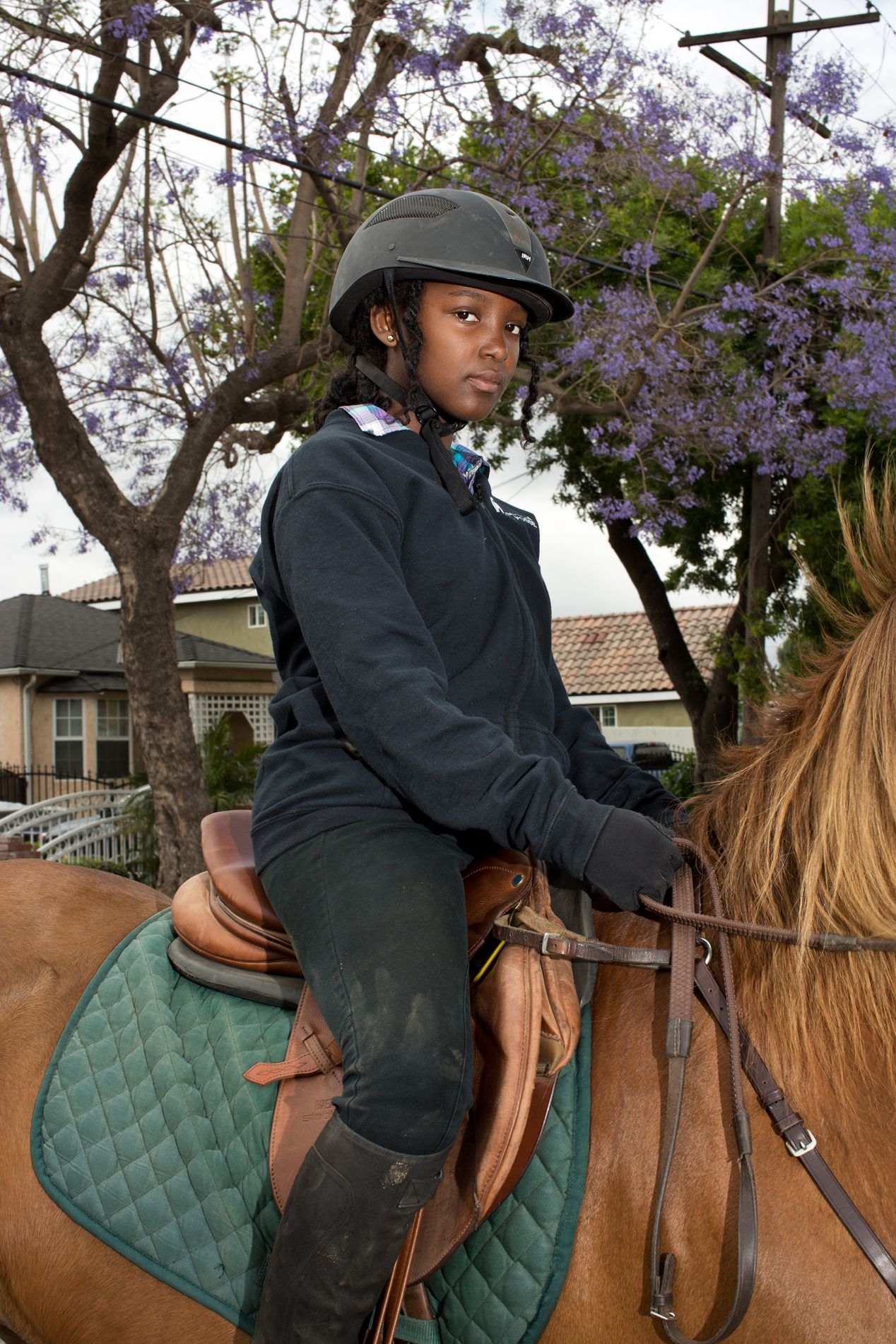 Young female equestrian on her horse, Ilona Szwarc, editorial photographer in Los Angeles.