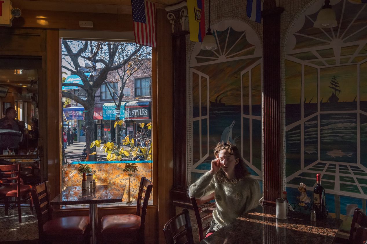 A woman sitting inside a restaurant, editorial portrait photography, Ilona Szwarc, Los Angeles.