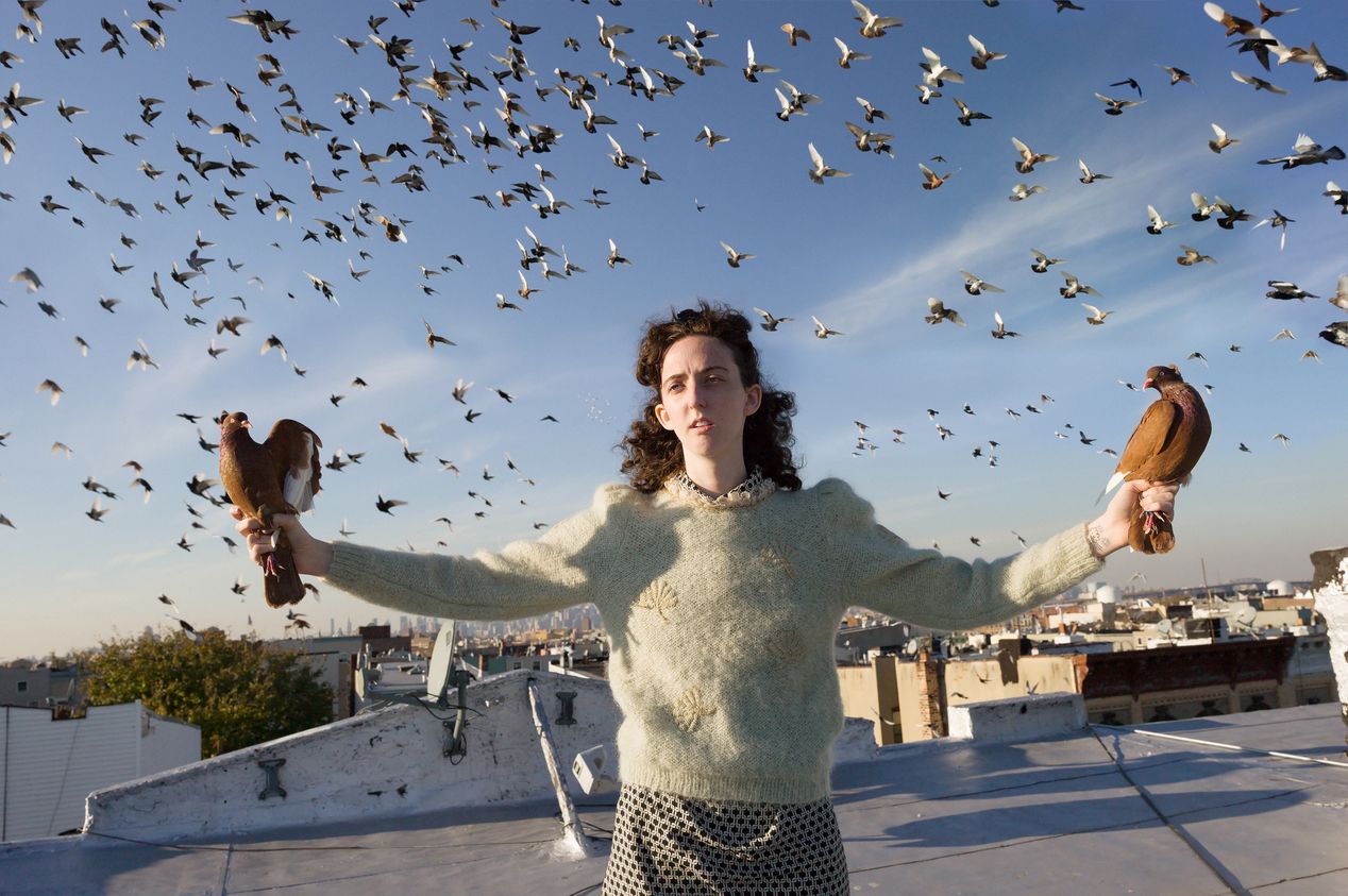 A woman holding two pigeons, editorial portrait photography, Ilona Szwarc, Los Angeles.