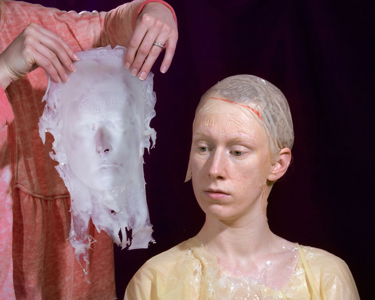 The reverse of the silicone mask is placed near the model's face, art photography, Ilona Szwarc, contemporary Los Angeles artist.