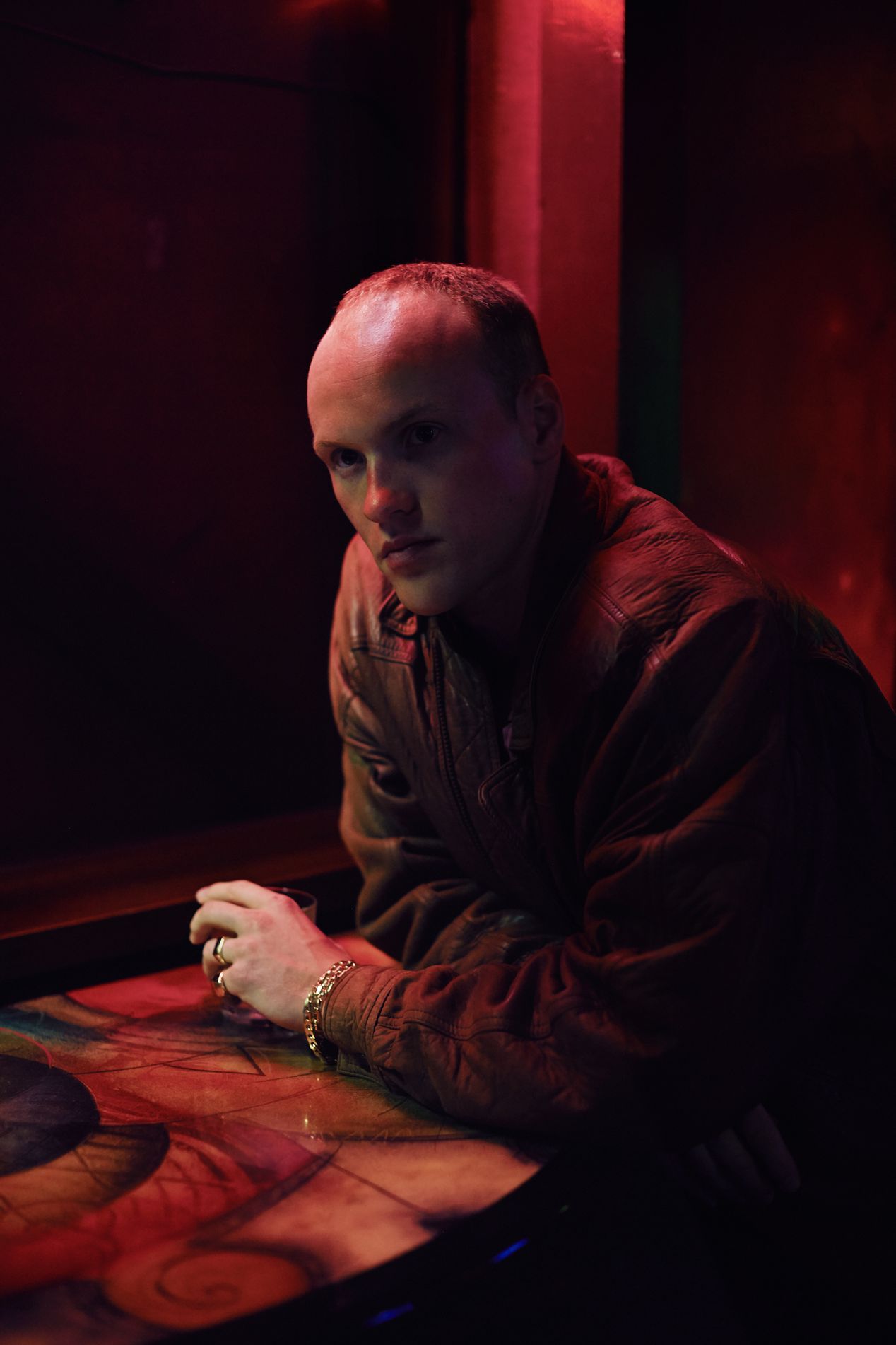 Portrait of a bald man in a dark pink light, Ilona Szwarc, Los Angeles environmental portrait photographer.