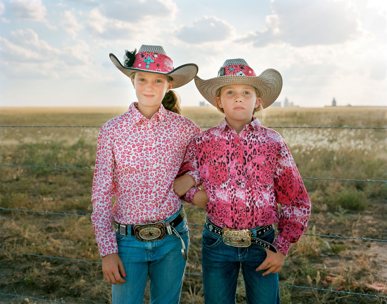 Sisters in pink patterned rodeo attire, environmental portrait photography, Ilona Szwarc, contemporary Los Angeles artist.